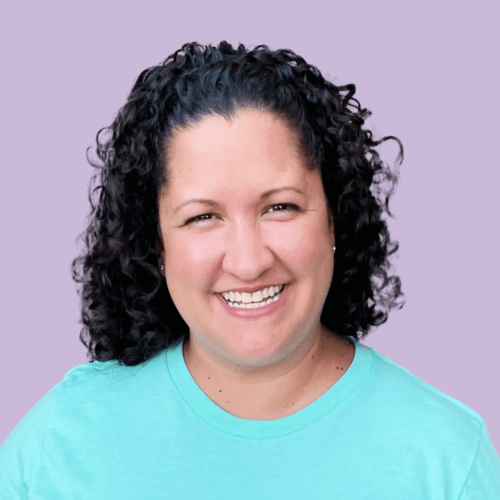 headshot of Carolina Ousley smiling wearing a teal shirt. Light purple background